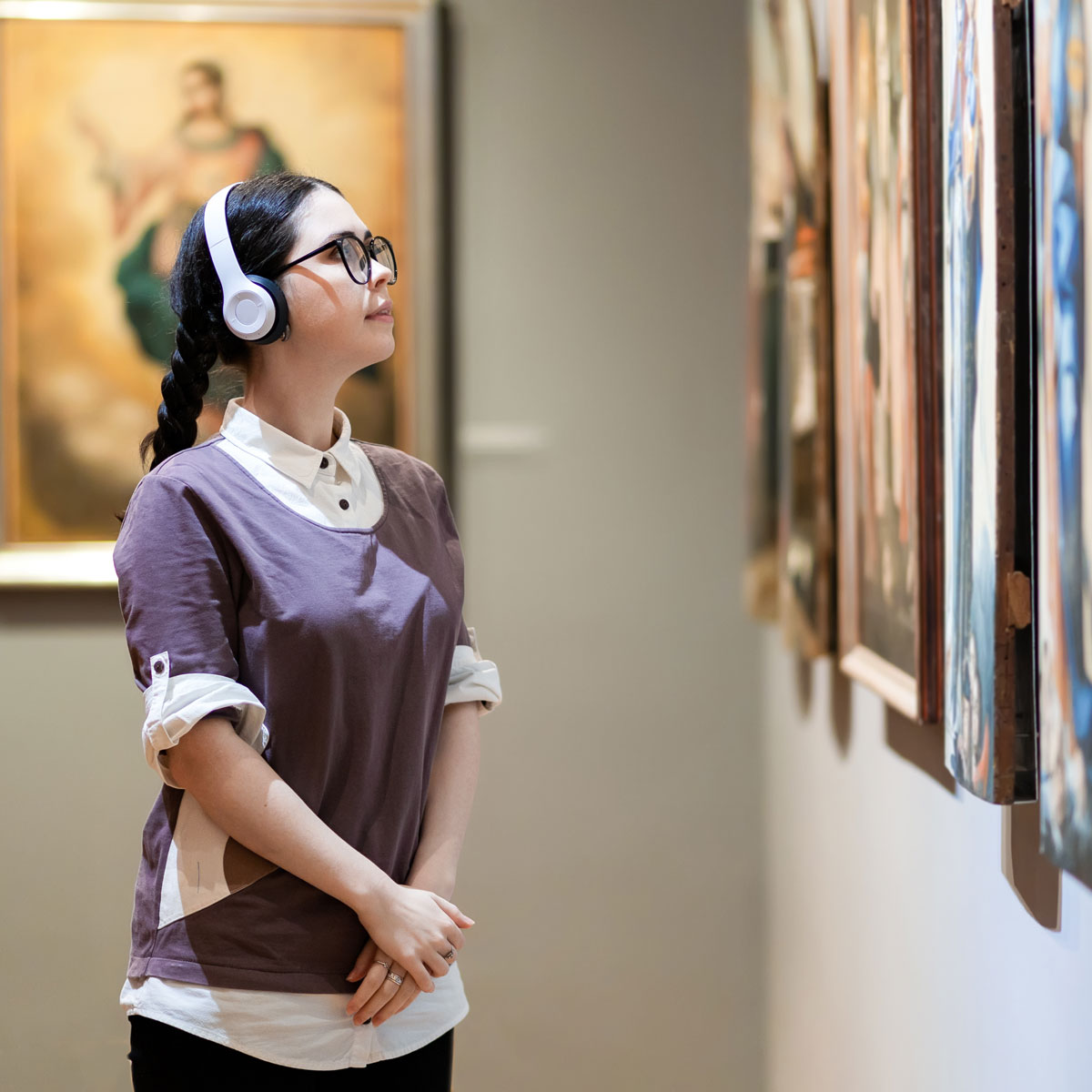 a woman in an art gallery viewing art