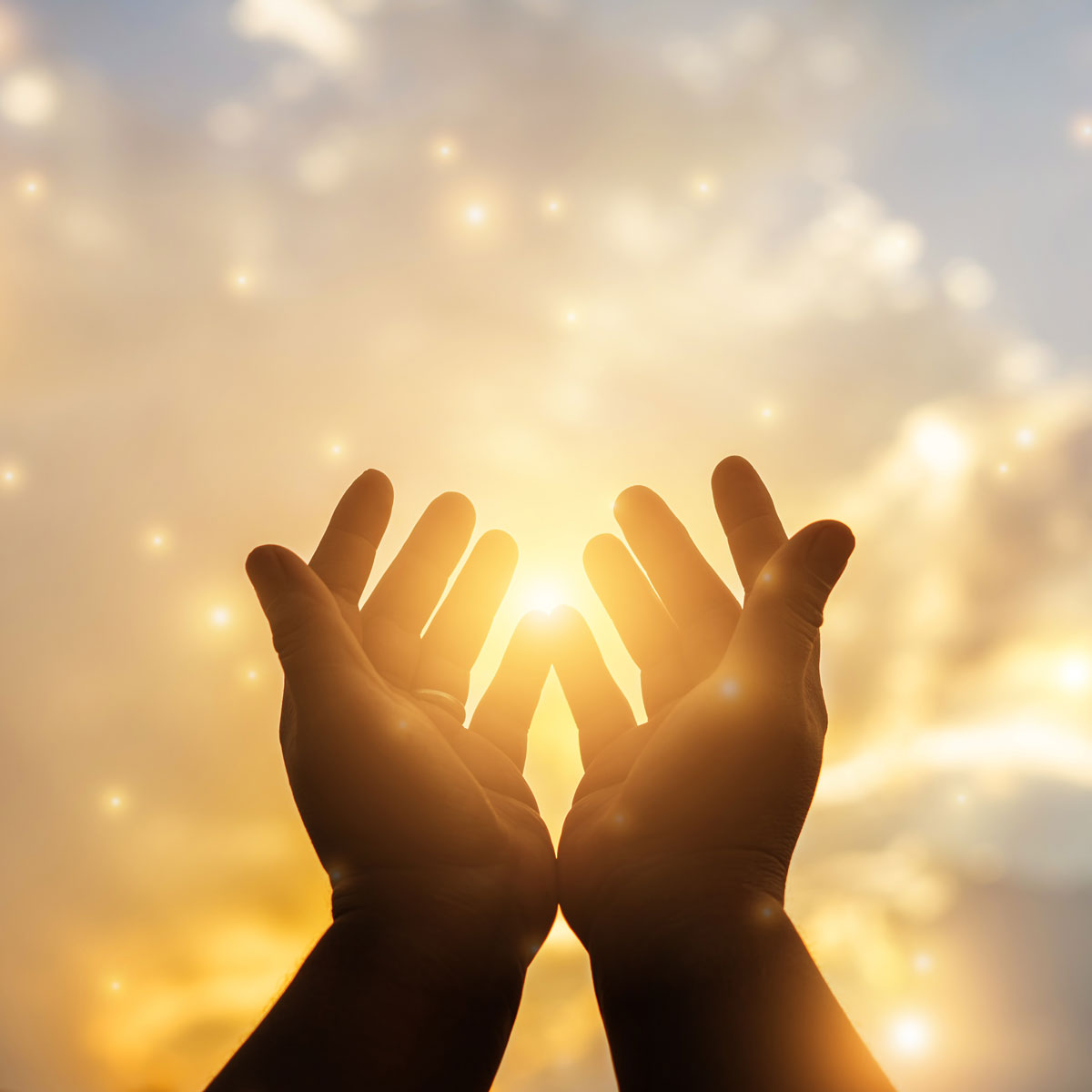 Hands glowing with sky background